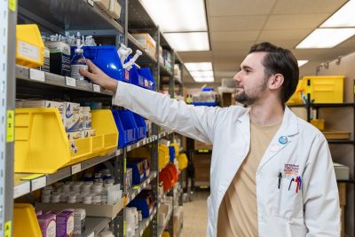 Logan Gillenwater working in the pharmacy at the Veterinary Teaching Hospital. 