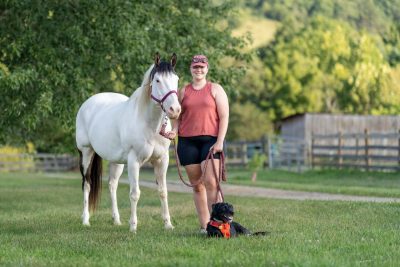 Rowdy, a 16 year old American Paint horse, his owner, Christie Goddard, and Goddard's dog, River
