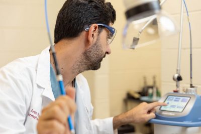 Ivan Ravera working with a carbon dioxide laser. The laser is used to remove warts, small tumors, and other lesions on a patient in lieu of surgery. Dr. Ravera came to the Veterinary Teaching Hospital already certified to use the laser and is interested in getting others certified as well.