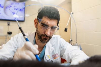 Ivan Ravera working with a carbon dioxide laser. The laser is used to remove warts, small tumors, and other lesions on a patient in lieu of surgery. Dr. Ravera came to the Veterinary Teaching Hospital already certified to use the laser and is interested in getting others certified as well.