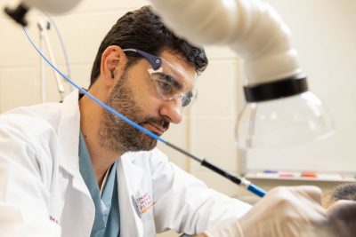 Ivan Ravera working with a carbon dioxide laser. The laser is used to remove warts, small tumors, and other lesions on a patient in lieu of surgery. Dr. Ravera came to the Veterinary Teaching Hospital already certified to use the laser and is interested in getting others certified as well.