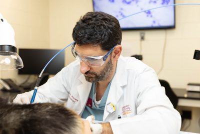 Ivan Ravera working with a carbon dioxide laser. The laser is used to remove warts, small tumors, and other lesions on a patient in lieu of surgery. Dr. Ravera came to the Veterinary Teaching Hospital already certified to use the laser and is interested in getting others certified as well.