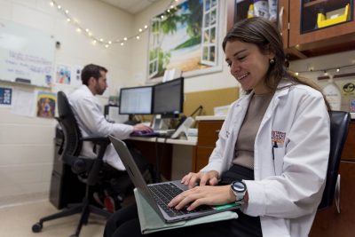 Two members of the ophthalmology team working on their computers at the Veterinary Teaching Hospital.